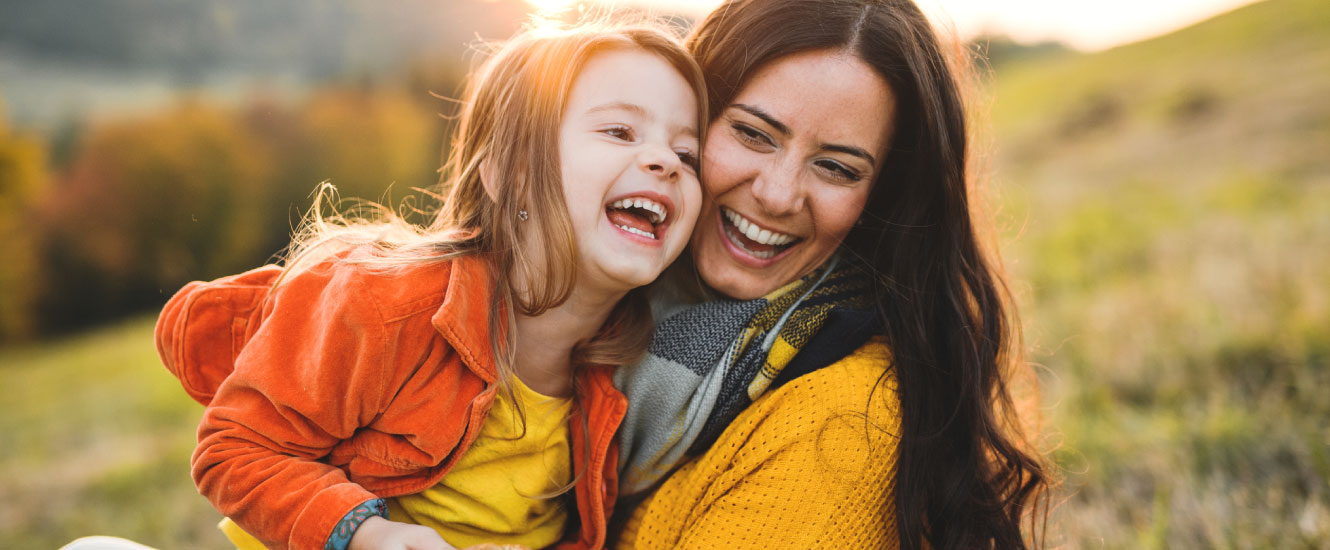 Mother and daughter in a sunny field