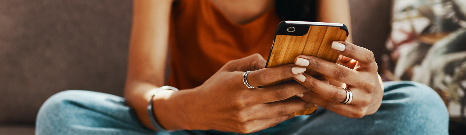 Close up of a person's hands holding a smartphone.