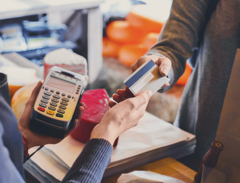 Close up of two people's hands exchanging a credit card